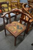 An Edwardian inlaid mahogany corner armchair.