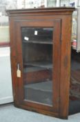 A 19th century oak hanging corner cabinet.