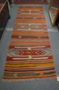 A Kilim runner 297cm x 95cm.