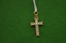 An 18ct white gold and diamond crucifix.