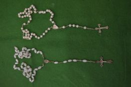 Two rosary necklaces with pearls and white beads.