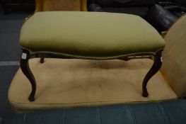 A Victorian walnut framed and upholstered large stool.