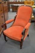 A Victorian mahogany framed and upholstered open armchair.