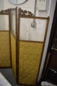 A gilt framed, glazed and upholstered folding dressing screen.