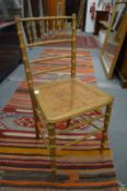 A pair of gilt wood faux bamboo occasional chairs.