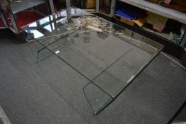 A stylish moulded rectangular glass coffee table.