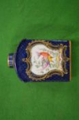 A porcelain tea canister decorated with exotic birds and insects.