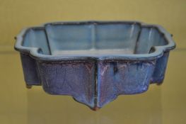 A Chinese turquoise glazed shallow jardiniere of unusual shape.