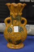 A Peruvian style twin handled figural vase.
