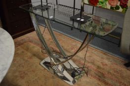 A stylish glass and chrome console table.