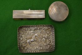 Small embossed silver dish and two other items.