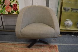 A grey upholstered swivel armchair.