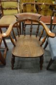 A 19th century beech and elm smokers bow armchair.