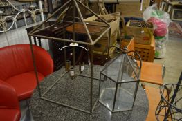 A hanging lantern and a terrarium.