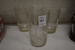 A Masonic glass beaker and pair of etched beakers.