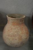 An early terracotta pottery bulbous shaped vessel.