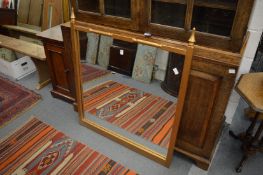 A gilt framed square shape mirror with turned finials.