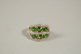 A 14CT YELLOW GOLD, DIAMOND AND GREEN STONE DECORATIVE DRESS RING, size N.