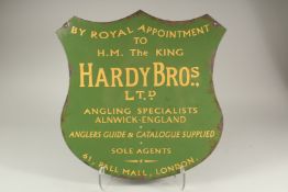 A GREEN HARDY BROS SHIELD SHAPED FISHING SIGN.