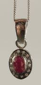 A GOLD PLATED SILVER OVAL RUBY AND R/C DIAMOND PENDANT on a gold plated silver chain, boxed. Ruby