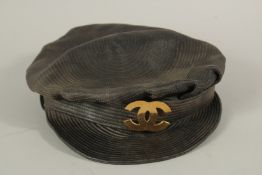 A CHANEL VINTAGE LEATHER AND CLOTH NEWS BOY HAT. Signed 56.