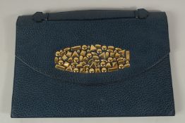 A RENAUD PELLEGRINO, PARIS, BLUE LEATHER BAG, the front with gold metal motifs, with carrying