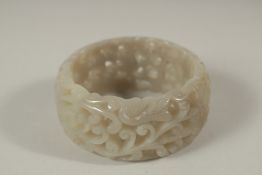 A CHINESE PIERCED JADE BANGLE. 7cms diameter x 3cms deep.