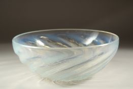 A LALIQUE CIRCULAR BOWL with spiral of fishes. 9.5cms diameter. Etched: R. Lalique, France.