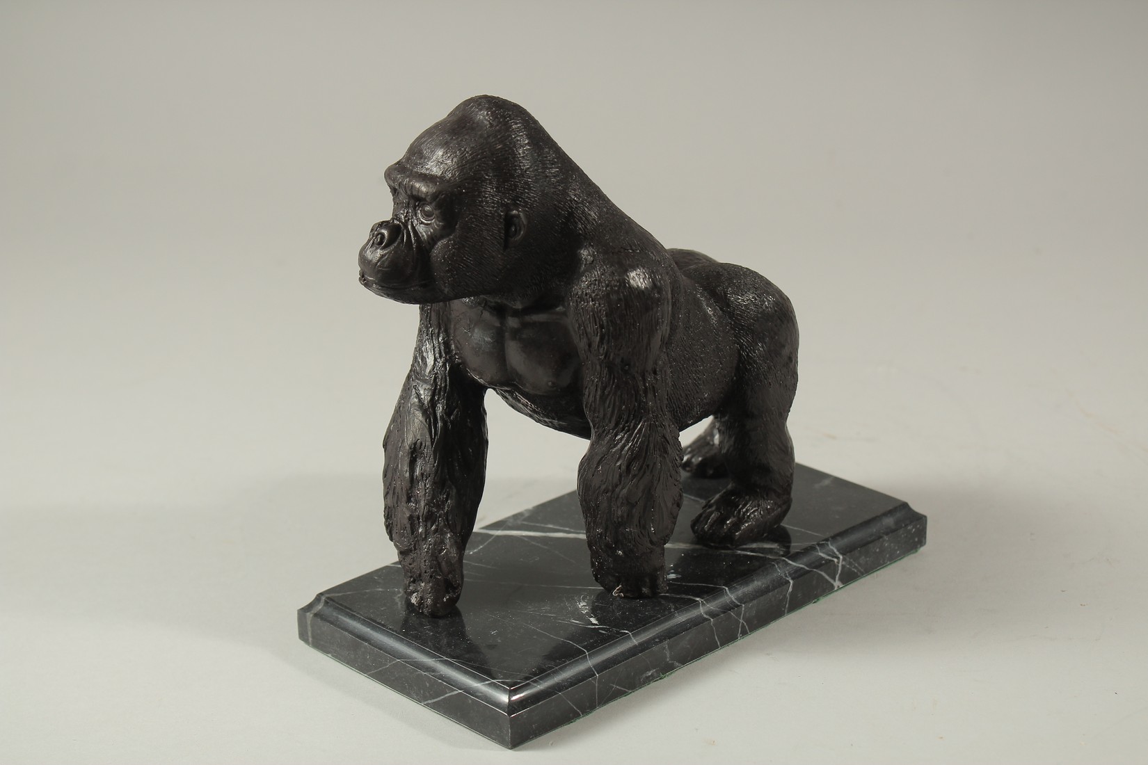 A BRONZE GORILLA on a marble base. 16cms long. - Image 2 of 2