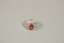 AN 18CT WHITE GOLD, DIAMOND AND ORANGE SAPPHIRE RING, size N.