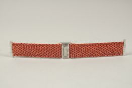 A BOUCHERON TAN STRAP in a Boucheron case. 14cms long.
