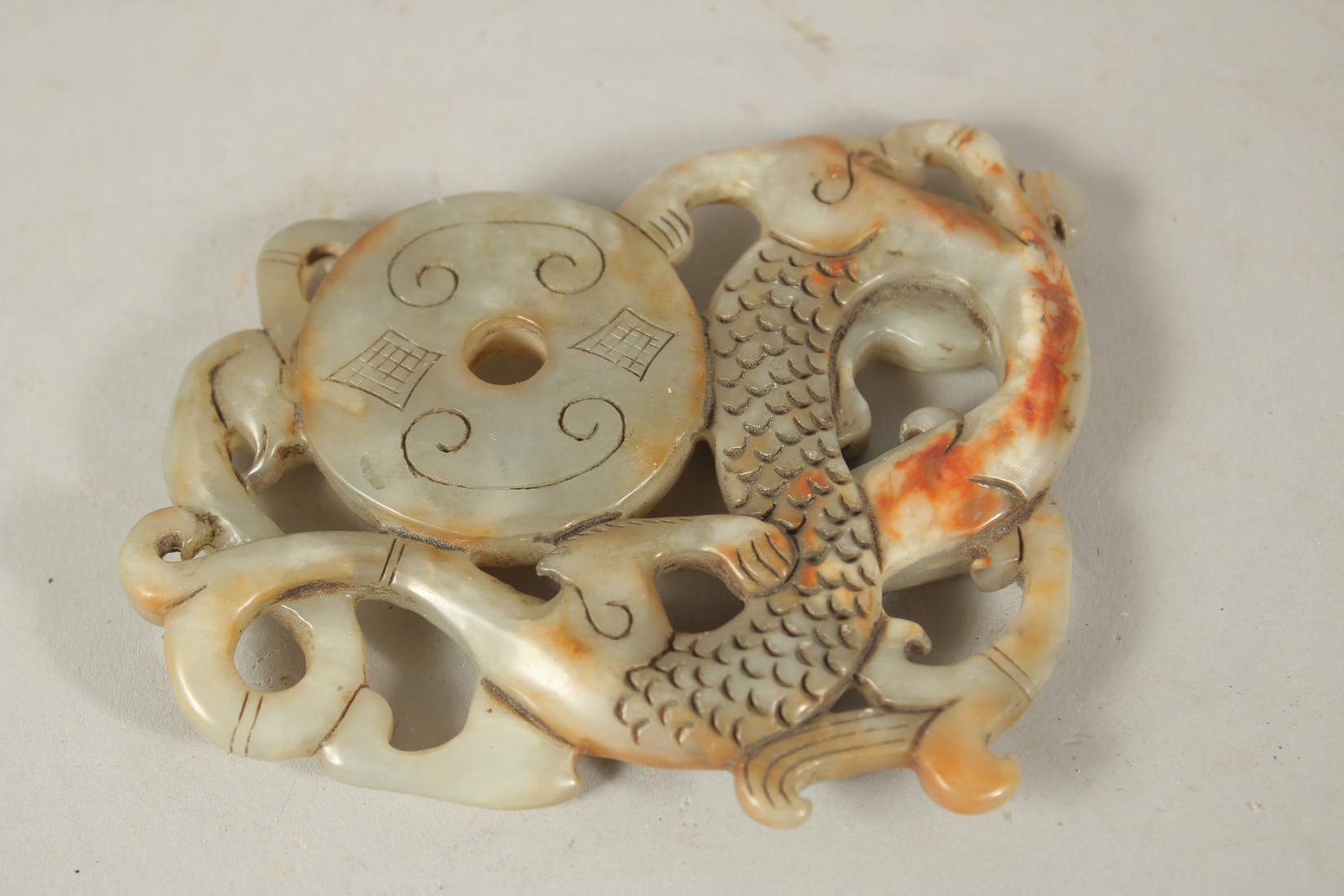 A CARVED JADE AMULET. 10cms x 8cms. - Image 2 of 2