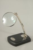 A MAGNIFYING GLASS on a stand.