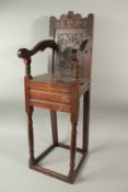 A CHILD'S 17TH CENTURY HIGH CHAIR, dated 1659, with carved back and solid seat. 3ft 6ins high x