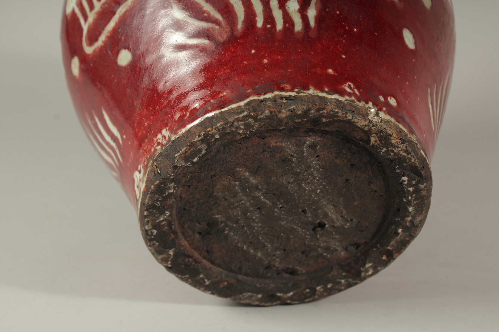 A CHINESE RED POTTERY BULBOUS VASE decorated with fish. 24cms high. - Image 4 of 4