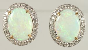 A PAIR OF 18CT WHITE GOLD OVAL CABOCHON OPAL AND R/C DIAMOND STUDS, with Omega-style fastenings,