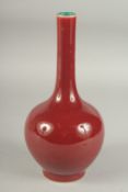 A CHINESE OXBLOOD GLAZE PORCELAIN BOTTLE VASE, the base with character mark. 26cm high.