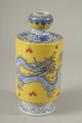 A CHINESE PORCELAIN YELLOW GROUND VASE decorated with dragons. 21cms high.