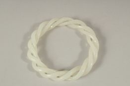 A CHINESE WHITE TWIST JADE BANGLE. 8.5cms diameter.