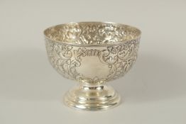 A VICTORIAN CIRCULAR ROSE BOWL with repousse decoration. 6ins diameter. Chester 1897.