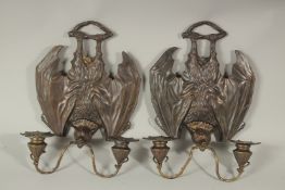 A PAIR OF BRONZE BAT SCONCES with double scrolling branches. 33cms long.