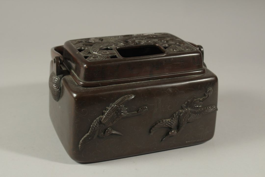 A GOOD CHINESE BRONZE SILVER INLAID CENSER with carrying handle and birds in relief. 18cms long. - Image 1 of 3