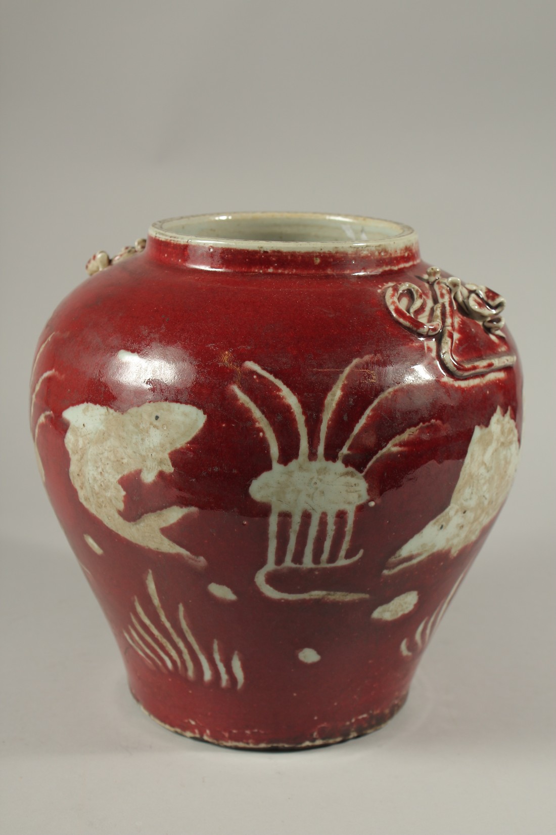 A CHINESE RED POTTERY BULBOUS VASE decorated with fish. 24cms high. - Image 2 of 4