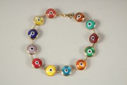 A 14CT GOLD COLOURED ENAMEL EYES BRACELET. 17cms long.