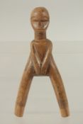 A CARVED WOOD TRIBAL CATAPAULT formed as a man. 7ins high.
