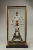 AN EIFFEL TOWER BRASS SKELETON CLOCK in a glass case. 56cms high.