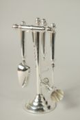 A SET OF FOUR SILVER PLATED BAR TOOLS on a stand.
