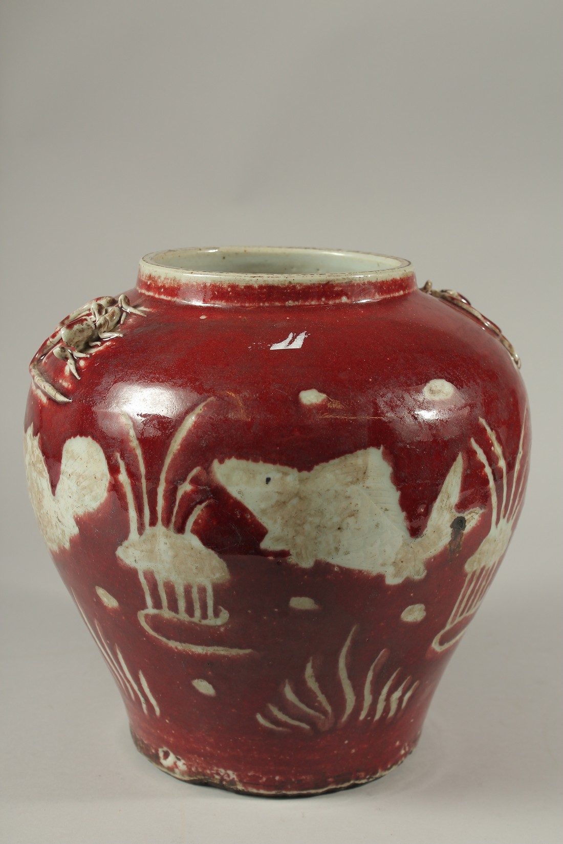 A CHINESE RED POTTERY BULBOUS VASE decorated with fish. 24cms high. - Image 3 of 4
