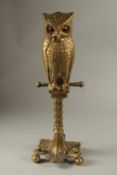 A CAST BRONZE OWL DOOR STOP. 60cms high.