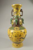 A LARGE CHINESE YELLOW VASE decorated with dragons. 42cms high.